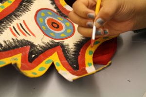 hand painting a mask doing touch up 