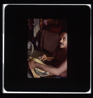 Slide photo of maskmaker working on a diablada mask