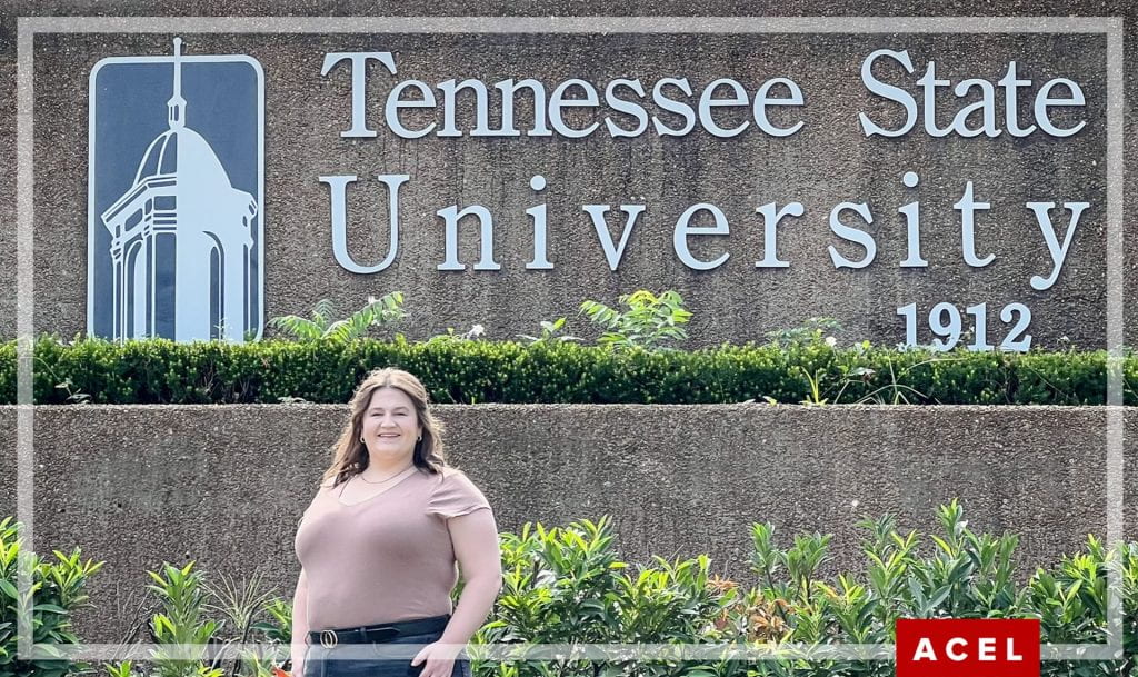Alyssa Rockers stands in front of a Tennessee State University sign on their campus.