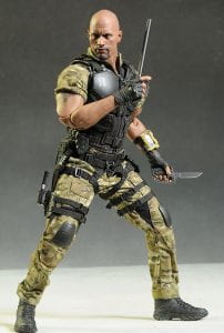 GI Joe doll from the 2000s holding weapons. He has visibly large, bulging muscles in his upper and lower body.