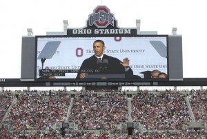 President Barack Obama is seen on a huge video screen as he speaks during the Ohio State University spring commencement in the Ohio Stadium, Sunday, May 5, 2013, in Columbus, Ohio. President Obama is the third sitting president to give the commencement speech at Ohio State University. (AP Photo/Carolyn Kaster)
