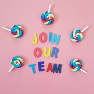the phrase Join our team on pink background with candy decorations