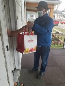 Barroluco staff delivery food to a Latinx/Hispanic family