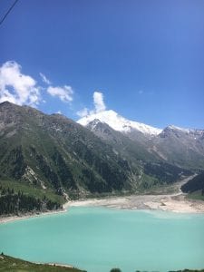 Bright blue lake between mountain peaks