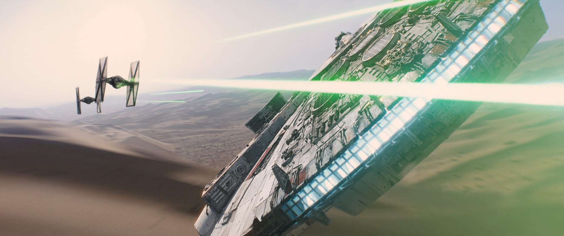 The Millennium Falcon flies at TIE Fighters in The Force Awakens